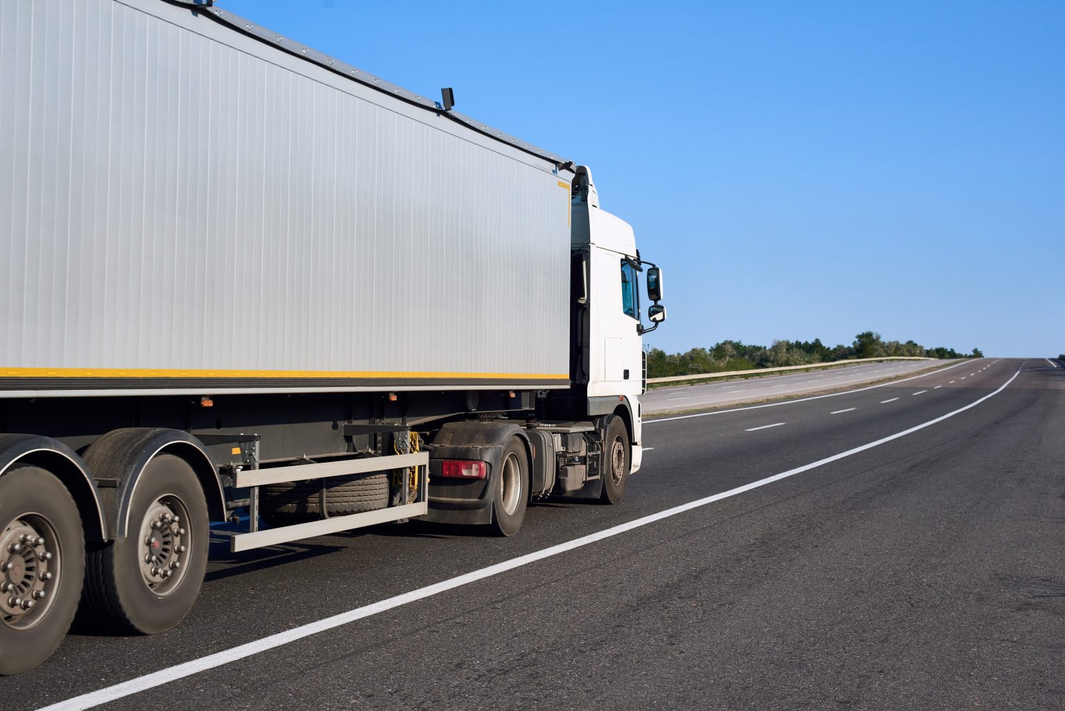 Truck on road with container, cargo transportation concept, closeup object