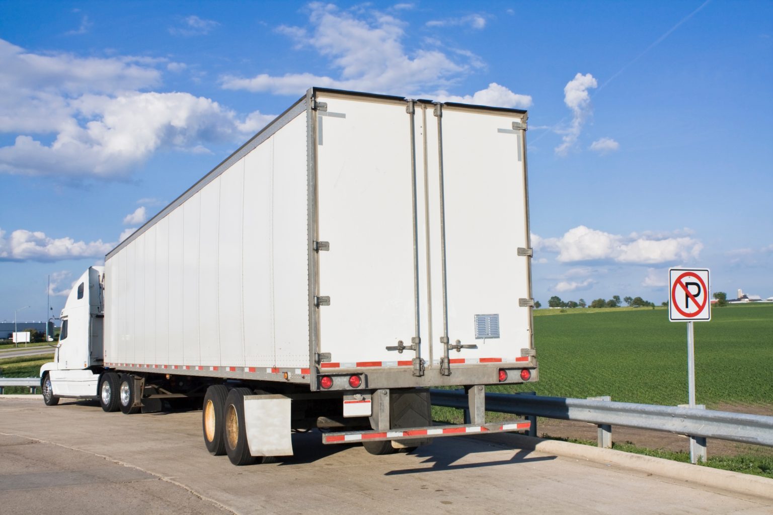 White Semi-Truck parked in forbidden spot.